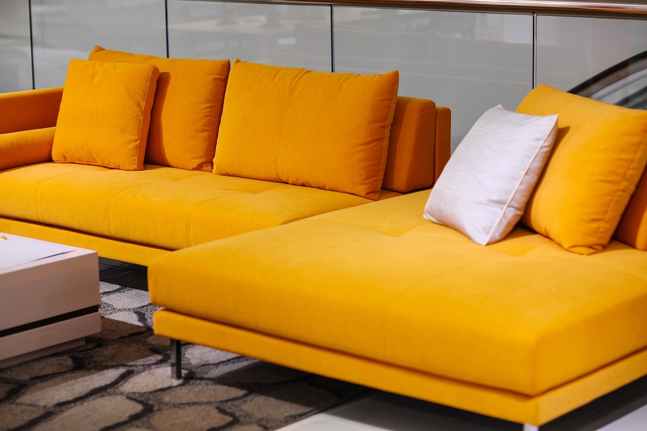 Vivid mustard-orange sectional sofa with pillows